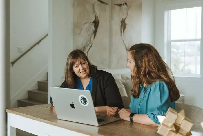 Janet and Michelle working on website project prep items