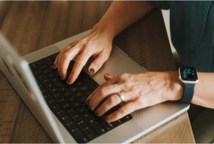 Janet's hands on her laptop keywoard